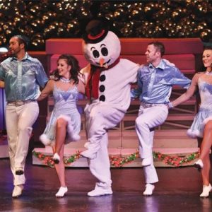 Frosty the Snowman dacing with the Country Tonite cast in their Pigeon Forge Christmas show.