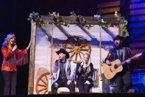 performers at Country Tonite Theatre sitting on a swing